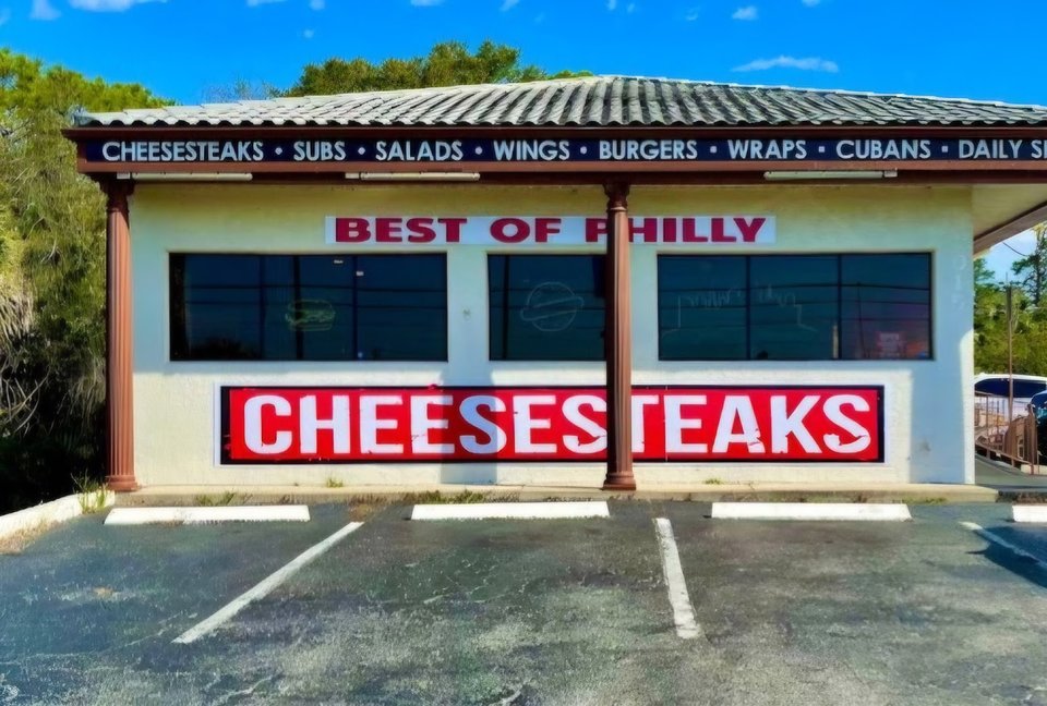 Cheesesteak sandwiches on a casual counter.